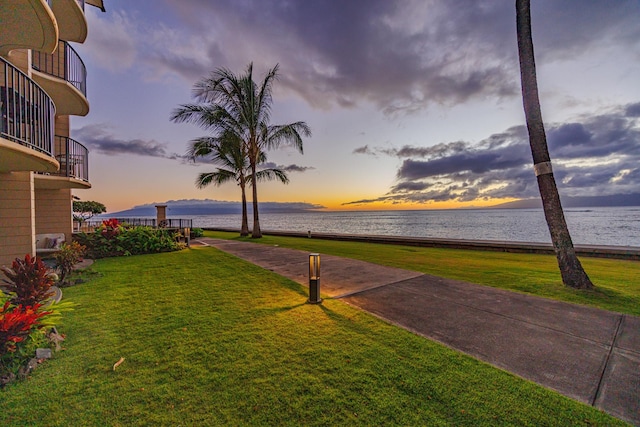 exterior space with a lawn and a water view