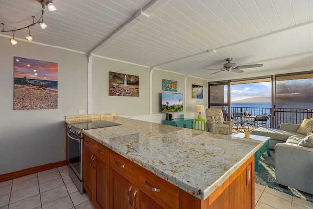 kitchen with electric range, a water view, open floor plan, a peninsula, and light tile patterned floors