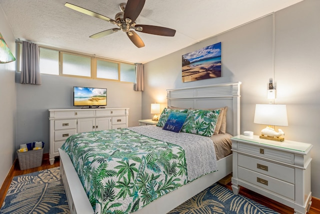 bedroom with ceiling fan, dark hardwood / wood-style floors, and a textured ceiling