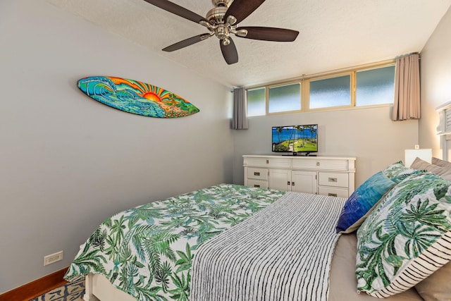 bedroom featuring a textured ceiling and ceiling fan