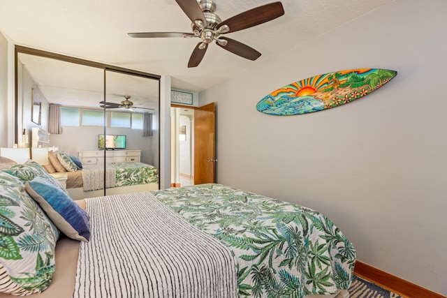 bedroom with ceiling fan and a closet