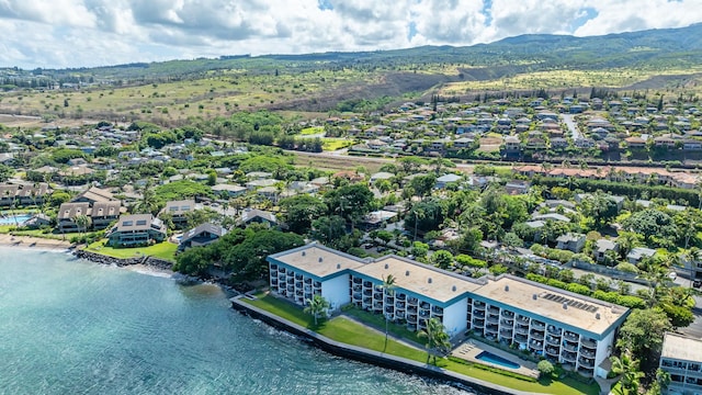 birds eye view of property with a water and mountain view