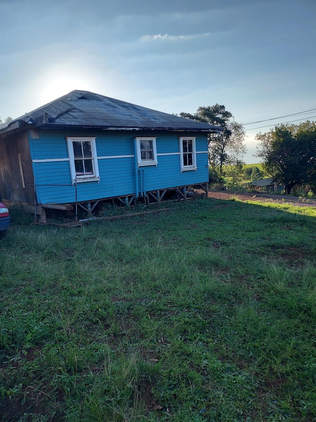 view of property exterior with a lawn