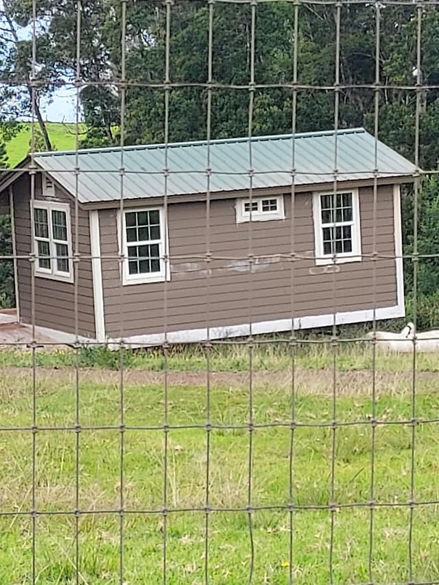 view of property exterior with an outbuilding