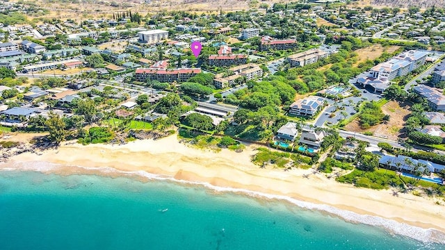 birds eye view of property with a view of the beach and a water view