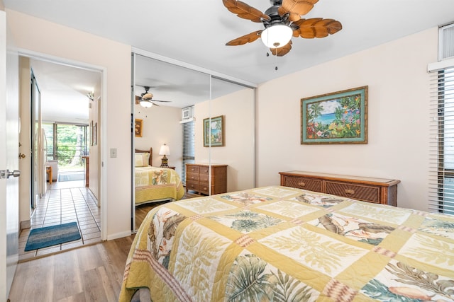 bedroom featuring light wood-type flooring, ceiling fan, and a closet