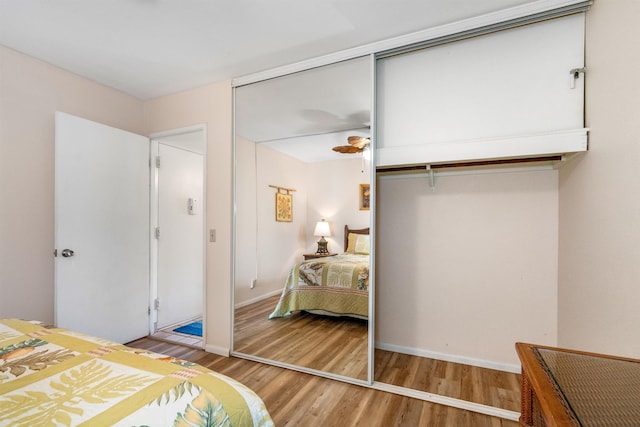 bedroom with light wood-type flooring and a closet