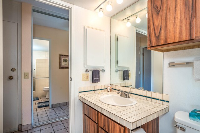 bathroom with tile patterned flooring, toilet, and vanity