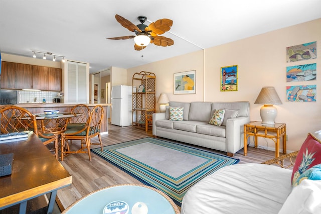 living room featuring light hardwood / wood-style flooring and ceiling fan