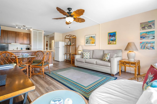 living area featuring light wood-style floors and ceiling fan