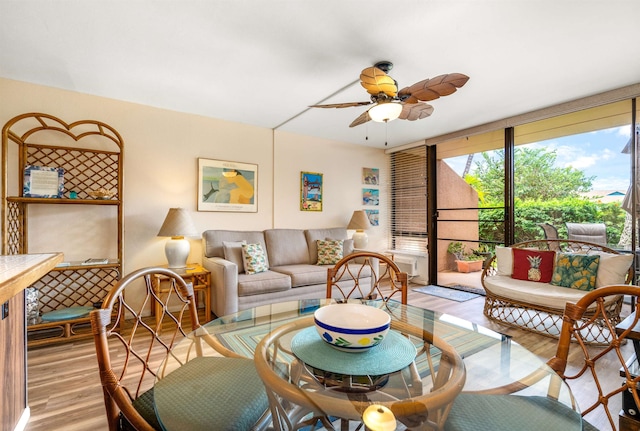 living room featuring ceiling fan and light hardwood / wood-style floors