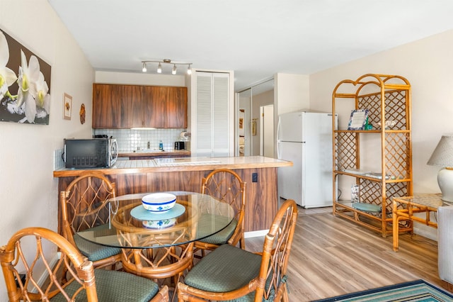 dining space with light hardwood / wood-style flooring