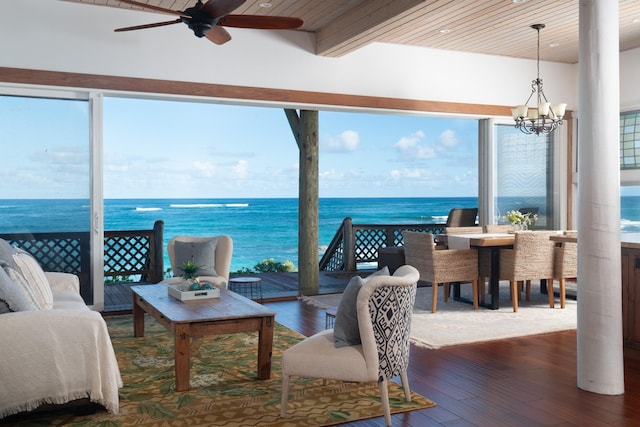 sunroom / solarium featuring a wealth of natural light, a water view, wood ceiling, and ceiling fan with notable chandelier