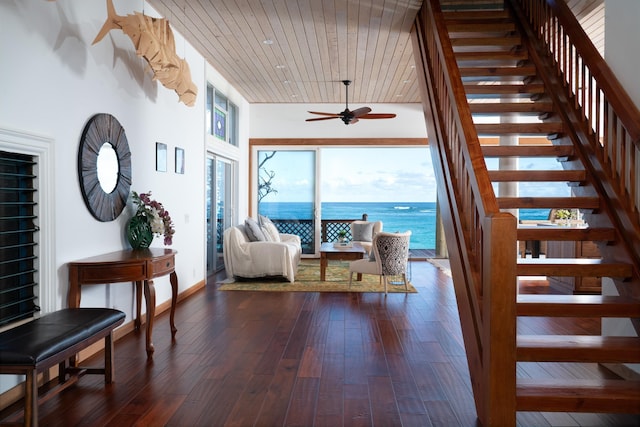 stairway with wooden ceiling, a water view, wood-type flooring, and ceiling fan