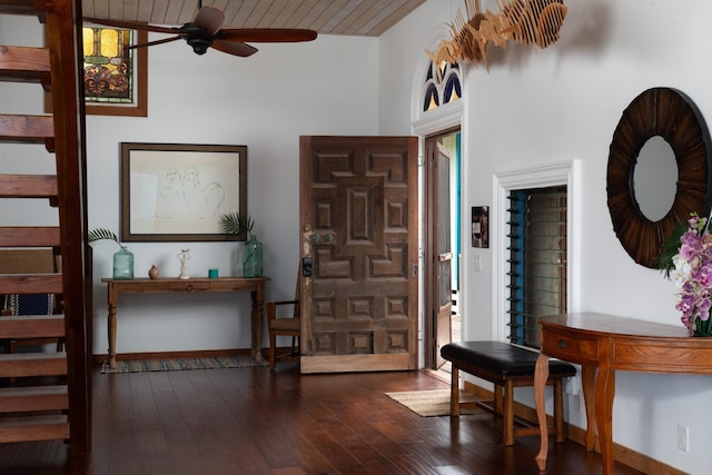 foyer with ceiling fan, dark wood-type flooring, a towering ceiling, and wood ceiling