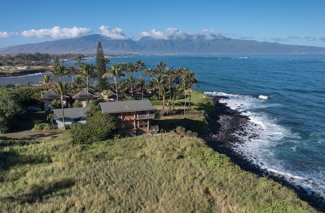 birds eye view of property with a water and mountain view