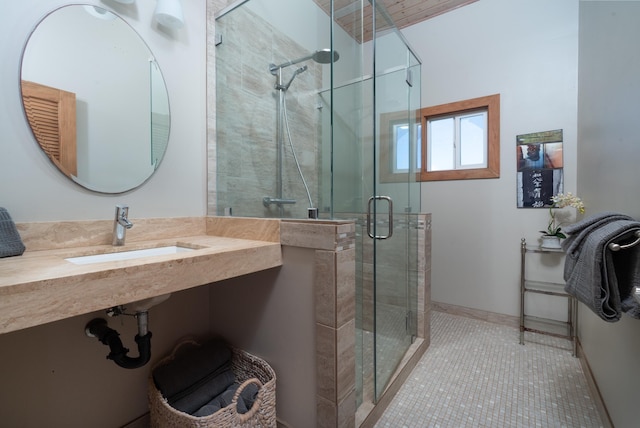 bathroom with tile patterned floors, sink, and a shower with door