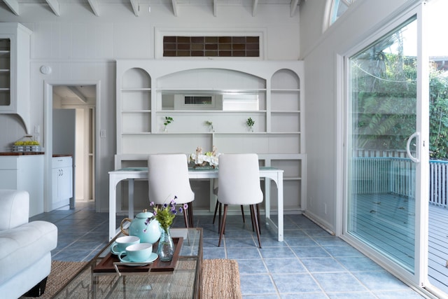 tiled dining room with built in shelves and beam ceiling