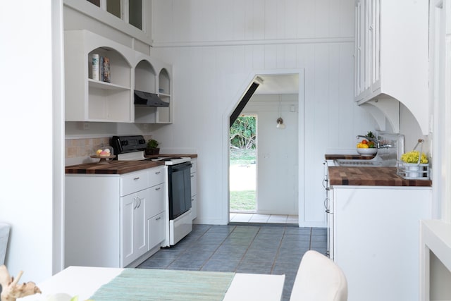 kitchen featuring tile patterned floors, sink, white electric stove, white cabinets, and butcher block counters