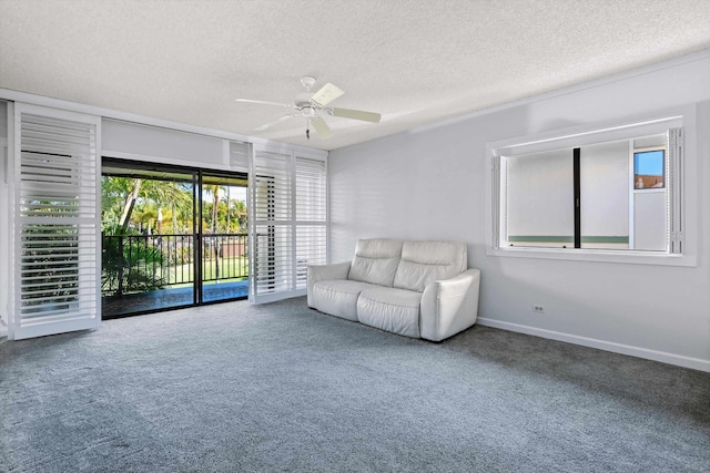 unfurnished room featuring ceiling fan, carpet floors, and a textured ceiling