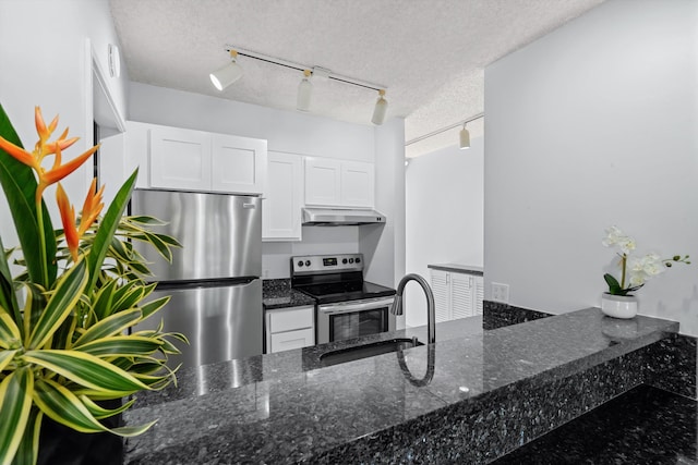 kitchen featuring white cabinets, track lighting, and appliances with stainless steel finishes