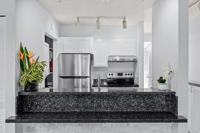 kitchen with appliances with stainless steel finishes, a textured ceiling, track lighting, and white cabinetry