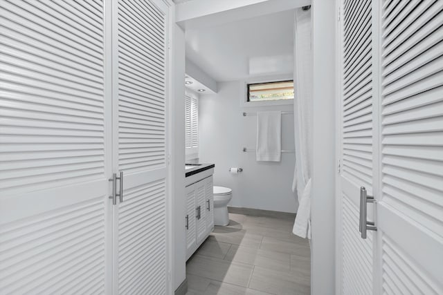 bathroom with tile patterned floors, vanity, and toilet