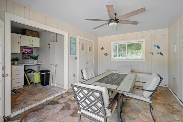 dining area featuring ceiling fan and water heater