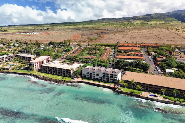 birds eye view of property with a water and mountain view