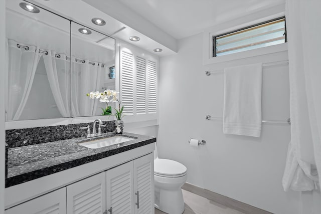 bathroom featuring a shower with curtain, vanity, and toilet