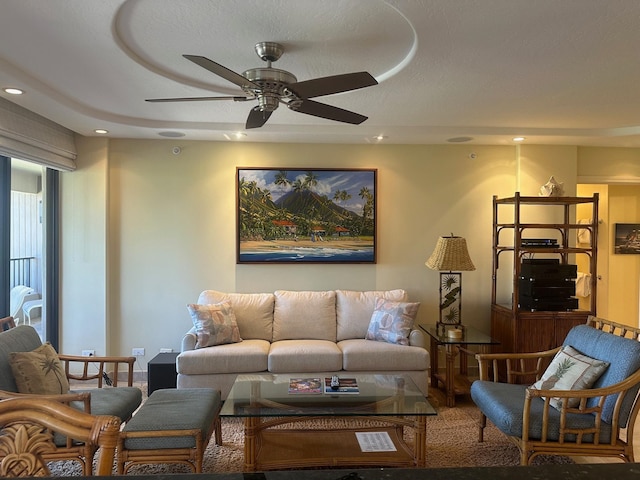 carpeted living room featuring a textured ceiling and ceiling fan