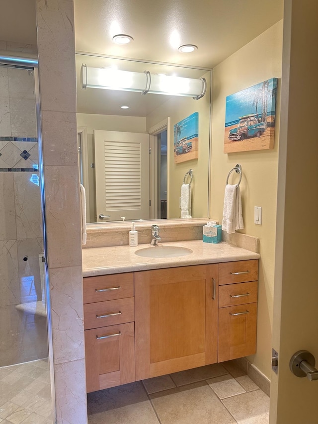 bathroom with vanity, tile patterned flooring, and a shower with door