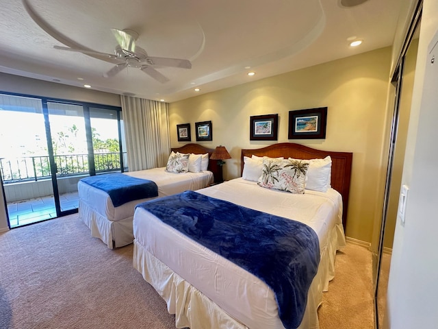 carpeted bedroom featuring access to exterior, ceiling fan, and a closet