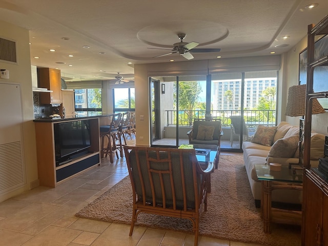 living room with a wealth of natural light and ceiling fan