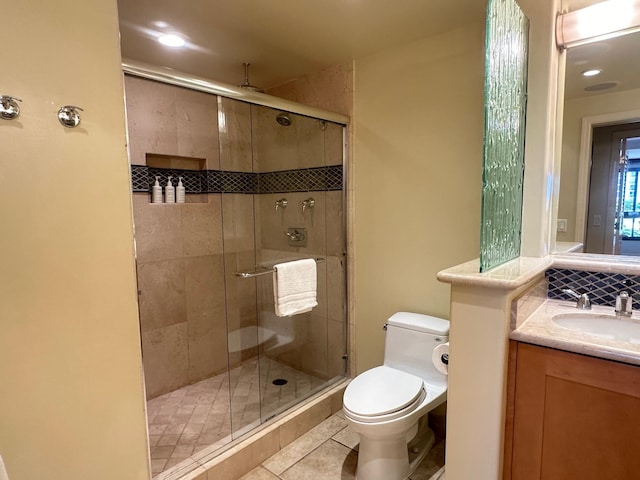 bathroom featuring an enclosed shower, tile patterned flooring, toilet, and vanity