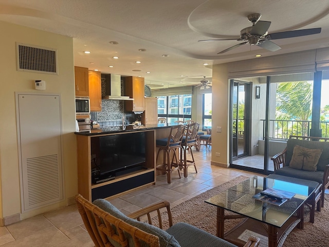 tiled living room with ceiling fan