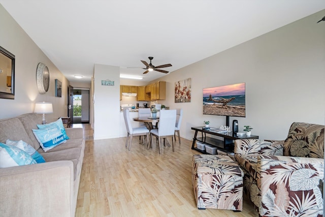 living room featuring ceiling fan and light hardwood / wood-style floors