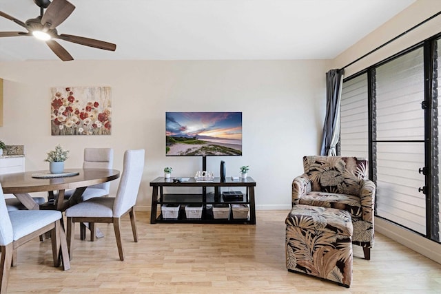 dining space with ceiling fan and light hardwood / wood-style flooring