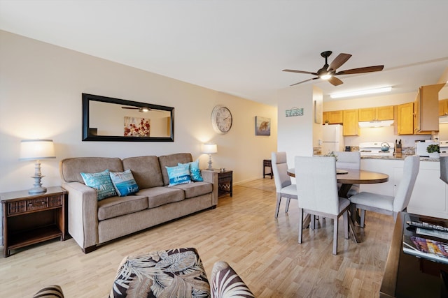 living room with ceiling fan and light hardwood / wood-style flooring