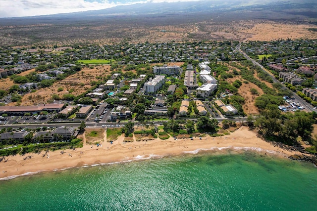 bird's eye view featuring a water view and a beach view