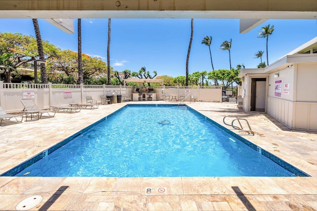 view of swimming pool with a patio