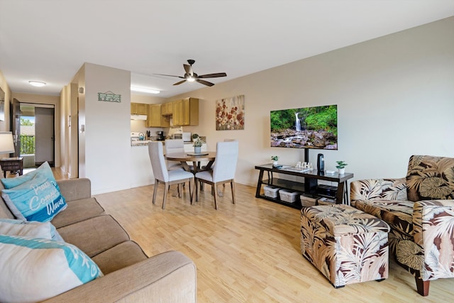 living room featuring ceiling fan and light wood-type flooring