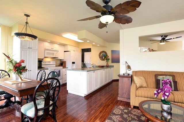 kitchen featuring pendant lighting, white appliances, dark hardwood / wood-style flooring, white cabinetry, and ceiling fan