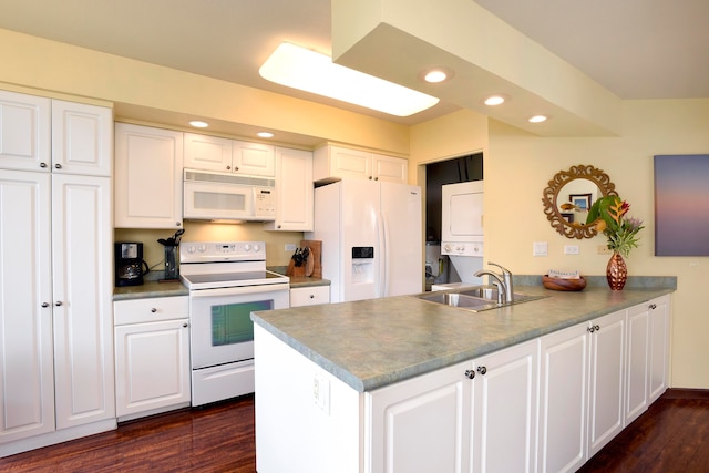 kitchen with white appliances, white cabinetry, stacked washing maching and dryer, and dark wood-type flooring