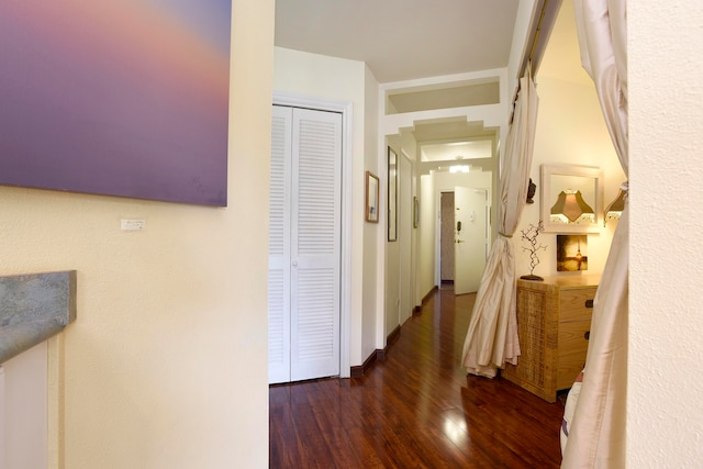 corridor with dark hardwood / wood-style floors