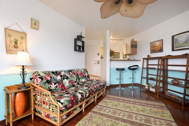 living room with dark wood-type flooring and ceiling fan