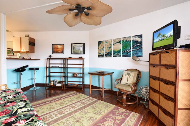 living area featuring dark hardwood / wood-style flooring and ceiling fan