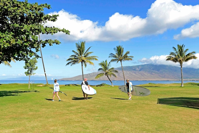 view of home's community featuring a lawn and a water and mountain view