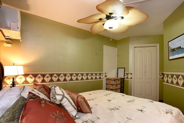 bedroom with a closet, water heater, and ceiling fan