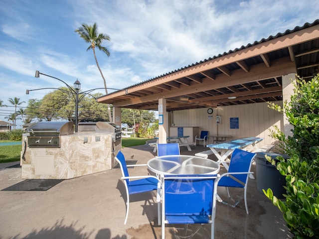 view of patio / terrace with outdoor dining area, a grill, and area for grilling